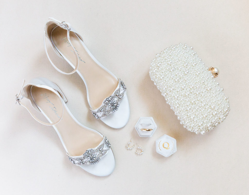 High End shoes, wedding rings, and purse shot in a light an editorial style.