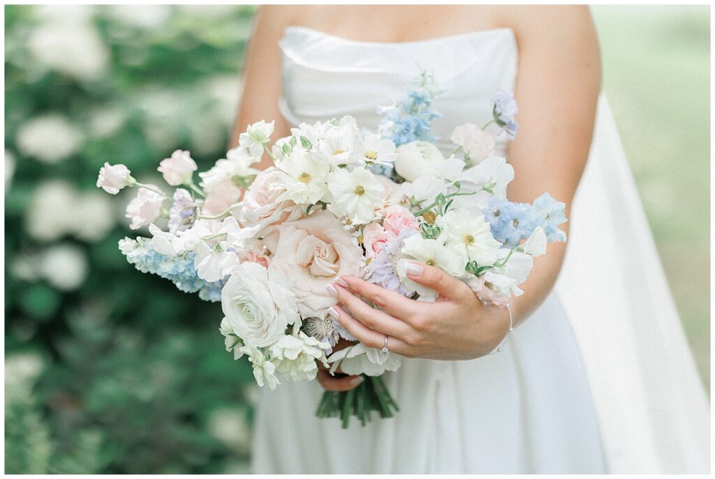 Bridal bouquet with soft pastel blues, whites, pink, and lavendar from Bespoke Blooms.